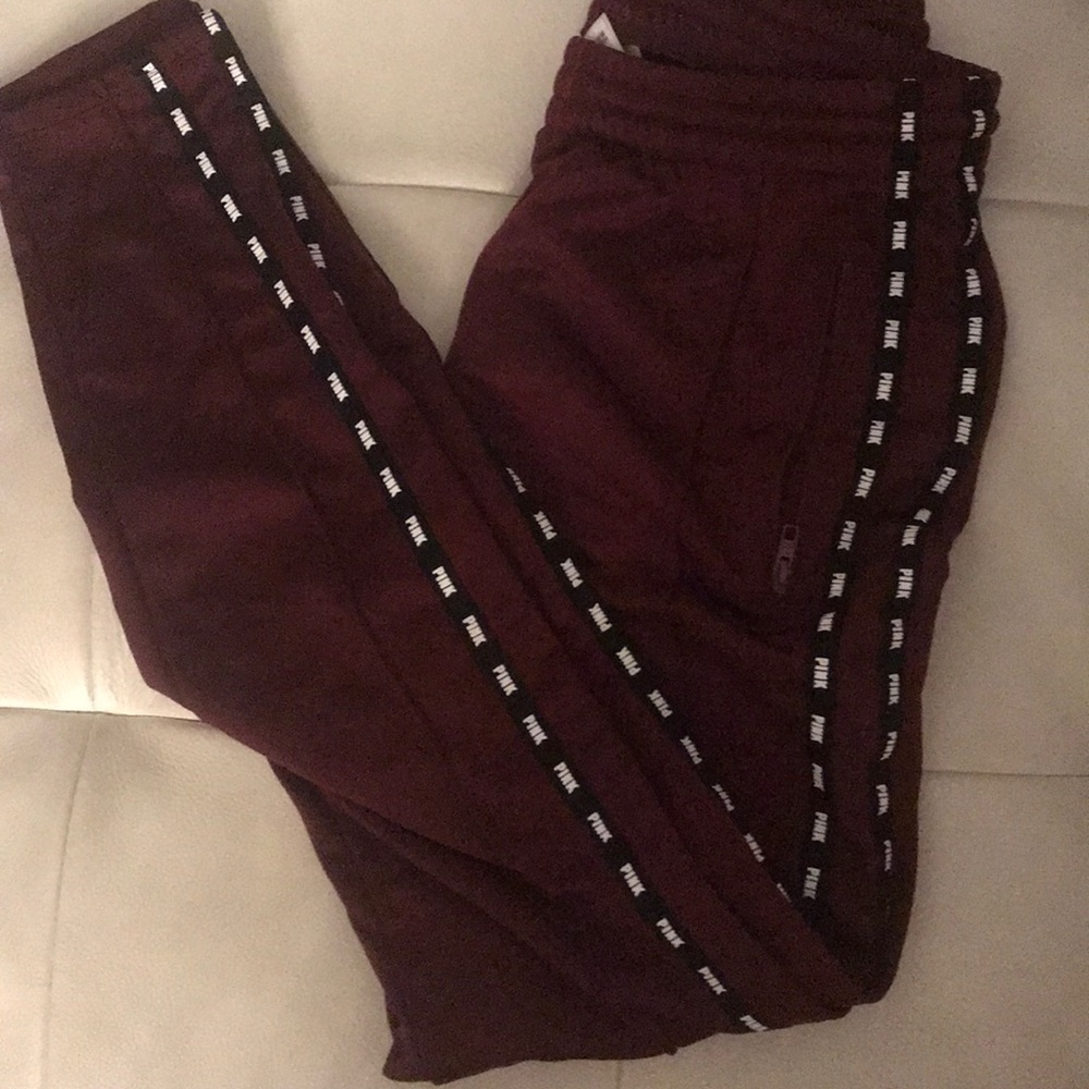 Red branded sweat pants.